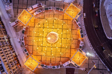 Aerial Top-Down View of a Glowing Christmas Tree and Light Display.