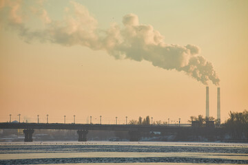 Industrial smokestacks emitting thick smoke into the sky.