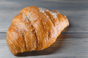 fresh baked croissant isolated on a wooden background