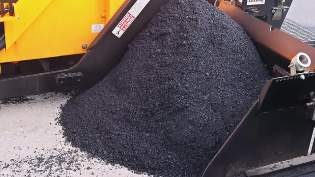 October 14 2025 New York USA Workers operate paving machine to lay new asphalt on construction road site