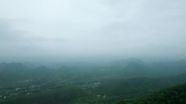4K Aerial view of Aravalli hills during cloudy monsoon day. Green Aravalli range as seen from Rayta in Udaipur, Rajasthan, India. Nature landscape.