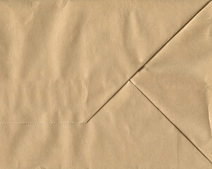 Brown crumpled and folded paper texture background. Kraft bag bottom.