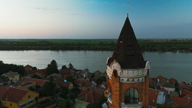 Aerial view of the Gardos Tower rising over red-roofed buildings along the river, bathed in the soft hues of twilight, Belgrade, City of Belgrade, Serbia.