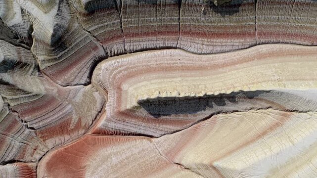 Aerial view of the textured landform showcasing a mix of colors and patterns, creating a visually stunning and abstract landscape, Kyzyl Kup Tiramisu, Mangystau Region, Kazakhstan.