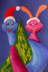 Snakes in santa hat around christmas tree made by child using gouache