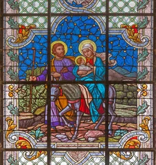Wandcirkels plexiglas Jezus Christus Vienna - The Flight to Egypt scene on the stained glass of church St. Laurenz (Schottenfelder Kirche) by prof. Rudolf Geyling (1897) in workroom Carl Geylings Erben.  © Renáta Sedmáková