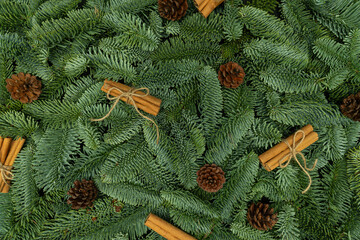 Evergreen Fir Branches with Cones and Cinnamon Sticks Christmas and New Year Flat Lay Background