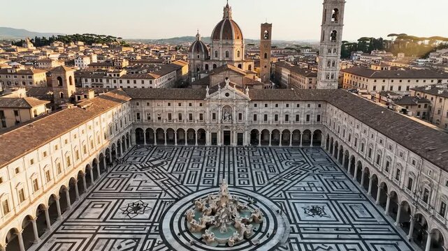 High angle aerial drone shot slowly sweeping over an expansive Italianate urban square featuring geometric patterns and surrounding terracotta rooftops highangle, geometric, large