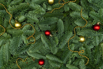 Evergreen Fir Branches with Golden Garland and Christmas Ornaments Flat Lay Background