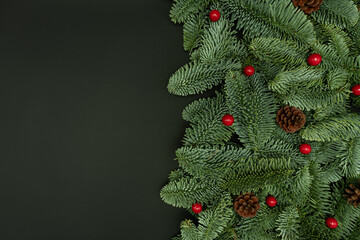 Evergreen Fir Branches with Red Berries and Cones Flat Lay on Dark Background with Copy Space