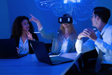 Team exploring new virtual reality technology in a modern office setting during an afternoon meeting