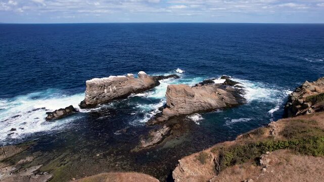 Aerial view of the rocky outcrops of The Stone Ships, where the dark blue sea crashes against the pale rocks, Sinemorets, Bulgaria.