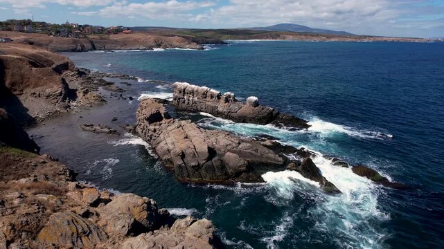Aerial view of the rugged Stone Ships coastline, where dark rocks meet the turquoise sea in a stunning display of nature's artistry, Sinemorets, Bulgaria.