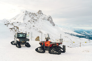 Tracked utility vehicles parked on a snowy mountain in Davos Klosters