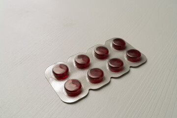 Red blister pack with cough drops for sore throat