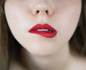 Fototapeta premium Close up beauty portrait of woman lips with red matte lipstick smooth skin and slightly open mouth expressing elegance sensuality and cosmetic makeup detail