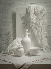 Still life with white dishes on a light background