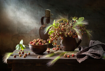 Still life with a bouquet of wild strawberries on a dark background