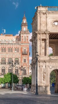 Morning timelapse of Central de Telefonica and the Town Hall in Plaza de San Francisco, Seville. Casa Consistorial, a masterpiece of Plateresque architecture with tram under a blue cloudy sky