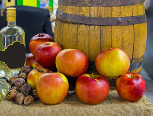 Apples in front of wooden barrel used for making and storing brandy alcohol 