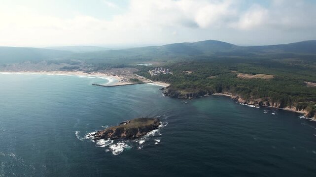 Aerial view of the serene Arkutino coastline where the deep blue sea meets sandy beaches and lush green forests, creating a stunning contrast, Arkutino, Primorsko, Bulgaria.