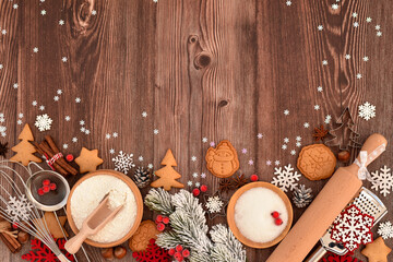 Festive Christmas background. Gingerbread baking preparation on a rustic wooden table during the holiday season