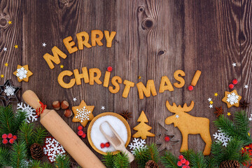 Holiday baking activity with festive decorations and tools for holiday preparation on a wooden background.