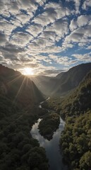 serene river winding through lush green mountains under a vibrant sunburst and cloudy sky.