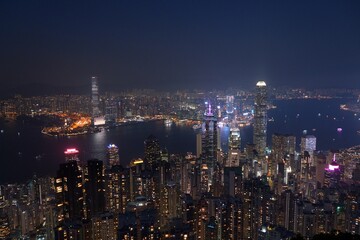 Hong Kong cityscape with Victoria Harbour. Night city view from Victoria Peak.