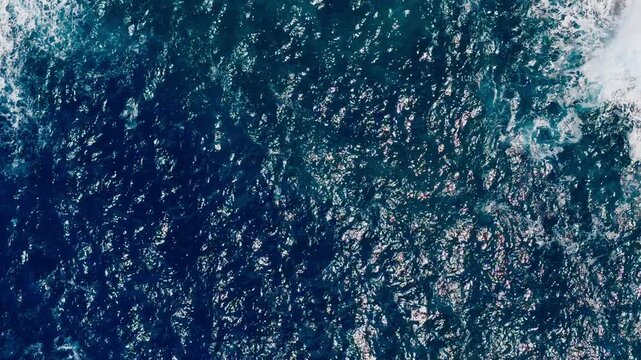 Aerial top down view of deep blue Mediterranean Sea with moving water surface. Natural background footage