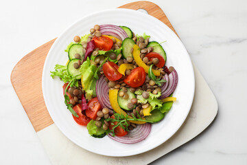 Tasty salad with lentils and vegetables on white marble table, top view