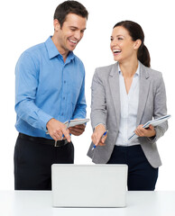 Two smiling professionals a man and a woman interacting while looking at a laptop screen and holding notebooks with one man pointing at the screen business team collaboration