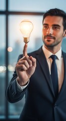 A well-dressed man in a suit is touching a glowing lightbulb, seemingly representing an idea. A bright background