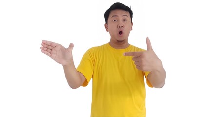 amazed and smiling happy Asian man pointing finger at copy space on left side or right side. Indonesian man pointing finger at advertisement.