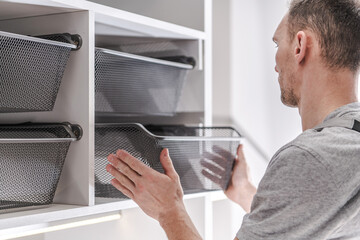 Organizing Storage Baskets in a Modern Home Setting During the Day