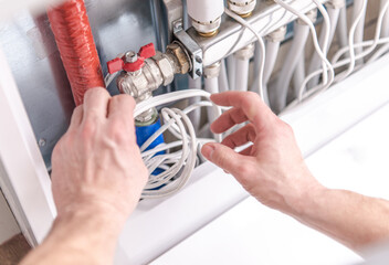 Maintenance of Plumbing System With Hands Adjusting Valve and Pipes