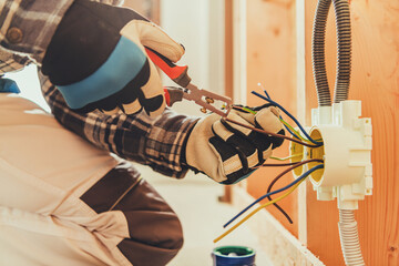 Electrician Works on Wiring Inside a Building During Renovation Tasks
