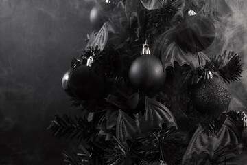 Gothic Christmas. A black Christmas tree adorned with dark ornaments and surrounded by mist