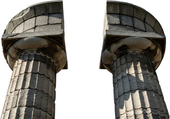 Fragments Of Two Ancient Weathered Stone Columns Displaying Carved Fluting And Ornate Capitals Stand Against A Stark Transparent Background Showing Texture And Shadow Detail Architecture