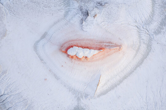 Aerial view of a surreal landscape where crisp white textures meet blushing pink hues in a stunning contrast, Senek, Mangystau Region, Kazakhstan.