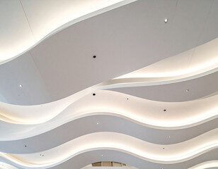 Modern wavy ceiling design with integrated soft lighting creating a futuristic architectural aesthetic