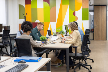 Diverse business people collaborating in vibrant modern office