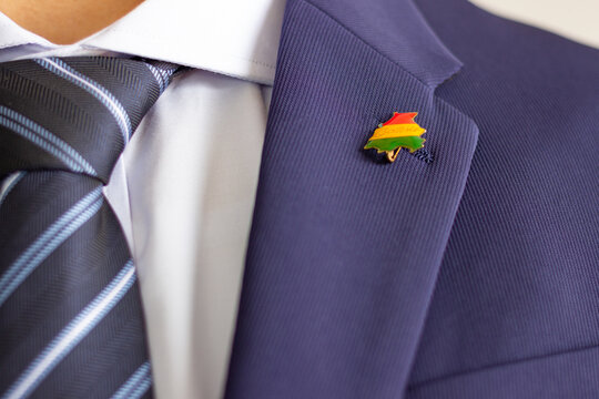Man wearing bolivian map flag lapel pin on suit