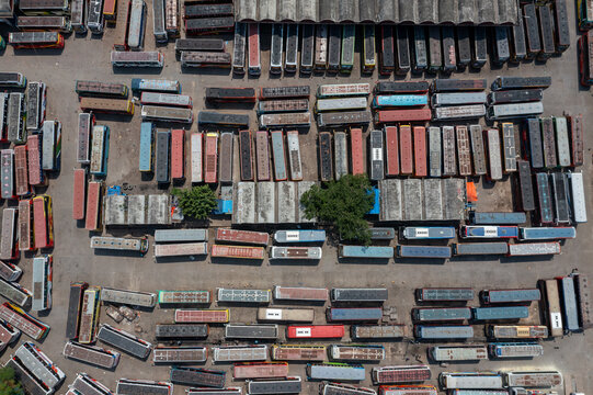 Aerial view of train carriages, lined up in dense rows, creating a textured tapestry of aged metal under the open sky, Dhaka, Dhaka Division, Bangladesh.