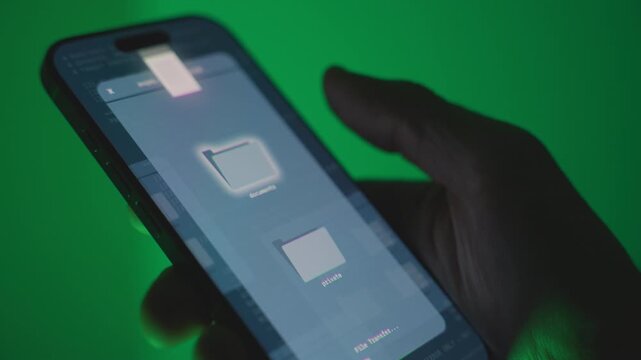 Close up on mobile device sending stealing or transferring digital documents. Spy hacker using smart phone device malware app exposing government secret files data and information or cyber attack