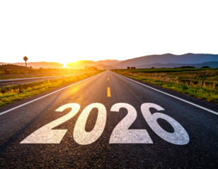 New year 2026 written on the road in the middle of asphalt road at sunset. Concept of