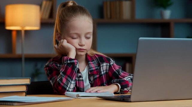 Tired Caucasian little girl child kid daughter studying online at home napping sleeping exhausted pupil with e-learning problem sleepy watching virtual lesson learn study course feeling bored fatigue