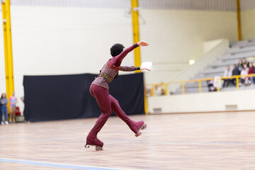 Artistic roller skater performing balance move in competition