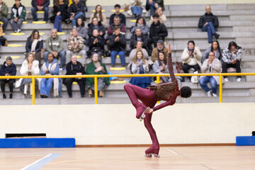 Skater performing acrobatic balance during artistic roller skate competition