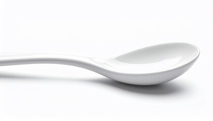 A close-up side view of a white, glossy spoon, casting a soft shadow on a white surface